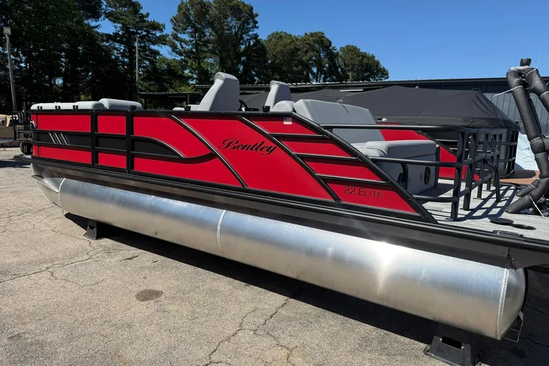 Slide: The Image of 2026 Bentley Pontoons Elite 223 Swingback in vibrant red, parked outdoors. - 3