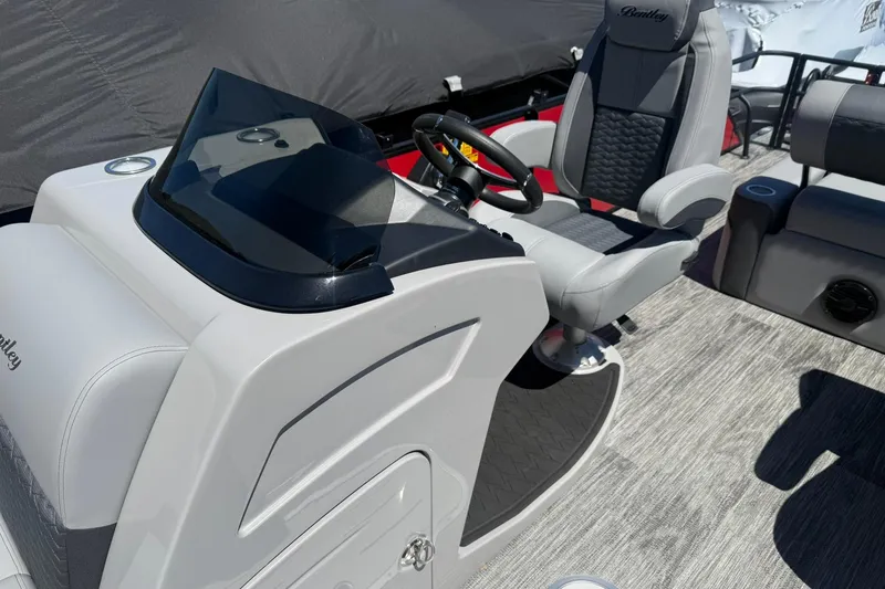 Slide: The Image of 2026 Bentley Pontoons Elite 223 Swingback interior with modern helm and seating. - 5