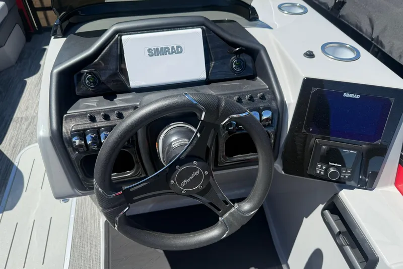 Slide: The Image of 2026 Bentley Pontoons Elite 223 Swingback dashboard with Simrad electronics and steering wheel. - 6