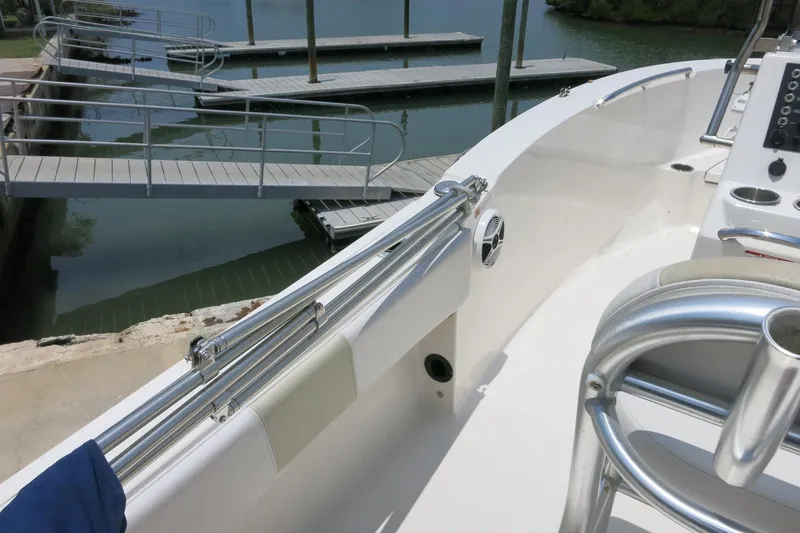 Slide: The Image of 2016 Robalo R180 Center Console boat docked at marina with metal railings. - 12