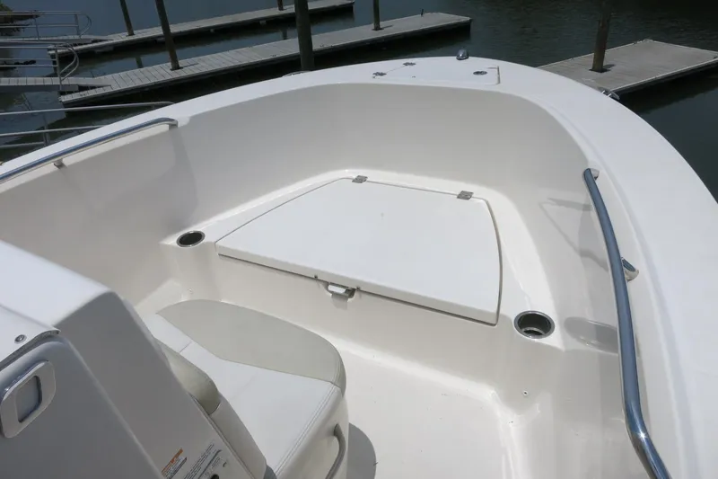 Slide: The Image of 2016 Robalo R180 Center Console boat interior with seating and storage. - 13
