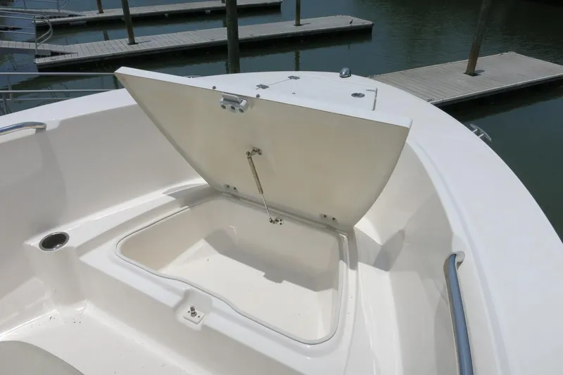 Slide: The Image of Open storage compartment on 2016 Robalo R180 Center Console boat at dock. - 15
