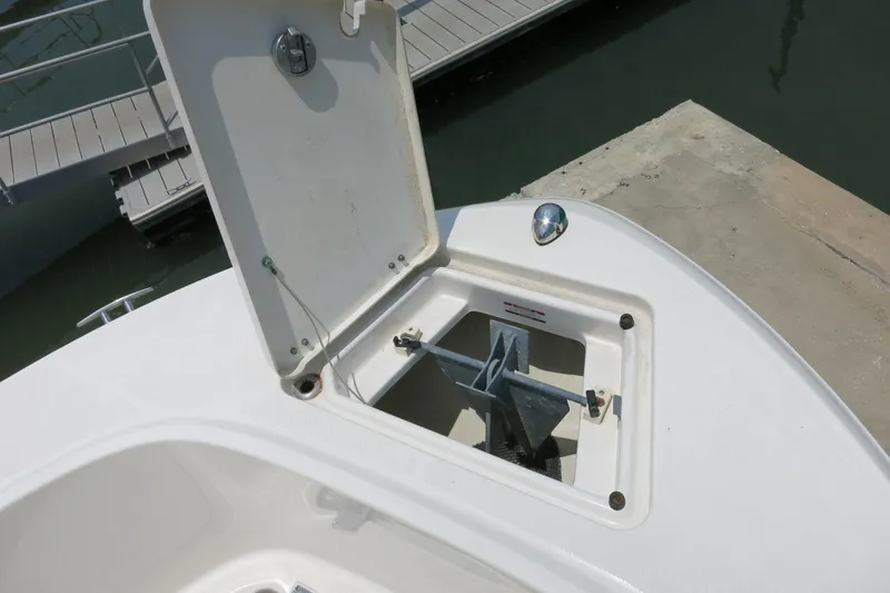 Slide: The Image of Open anchor compartment on 2016 Robalo R180 Center Console boat at dock. - 16
