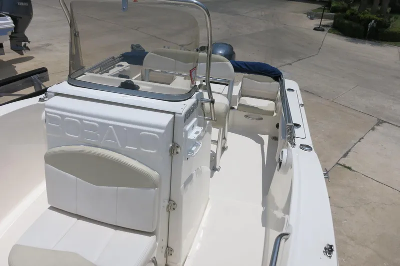 Slide: The Image of 2016 Robalo R180 Center Console boat with white seating and sleek design. - 19