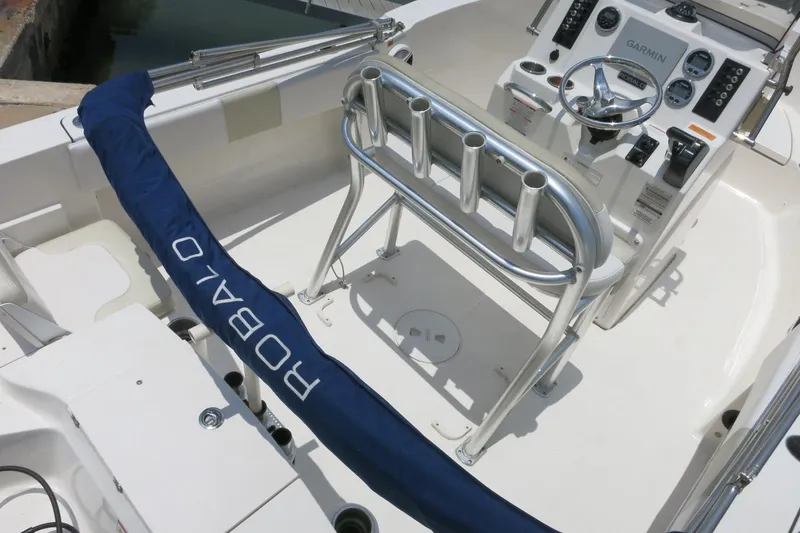 Slide: The Image of 2016 Robalo R180 Center Console boat interior with steering wheel and rod holders. - 22