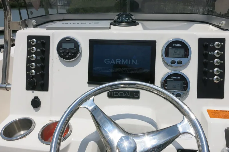 Slide: The Image of 2016 Robalo R180 Center Console dashboard with Garmin display and Yamaha gauges. - 25