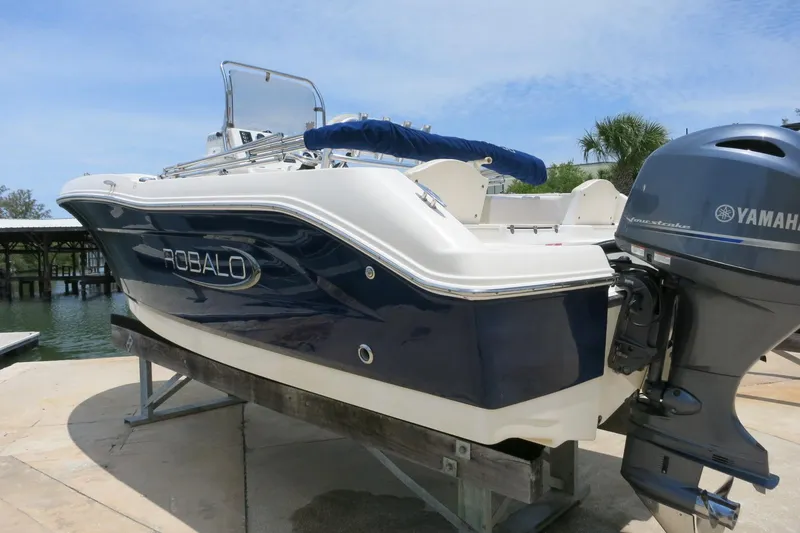 Slide: The Image of 2016 Robalo R180 Center Console boat with Yamaha outboard motor on a dock. - 7