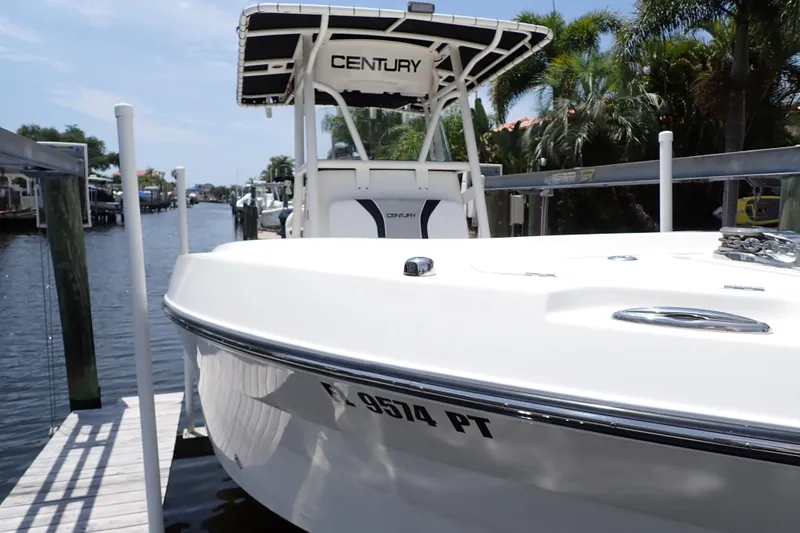 Slide: The Image of 2015 Century 2301 Center Console boat docked by a scenic waterfront. - 1