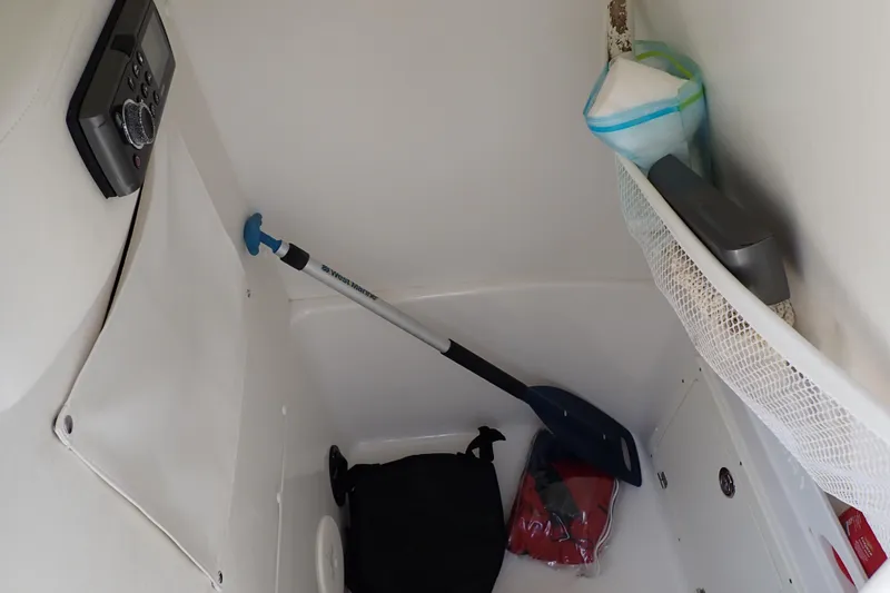 Slide: The Image of Storage compartment of a 2015 Century 2301 Center Console boat with various items. - 13