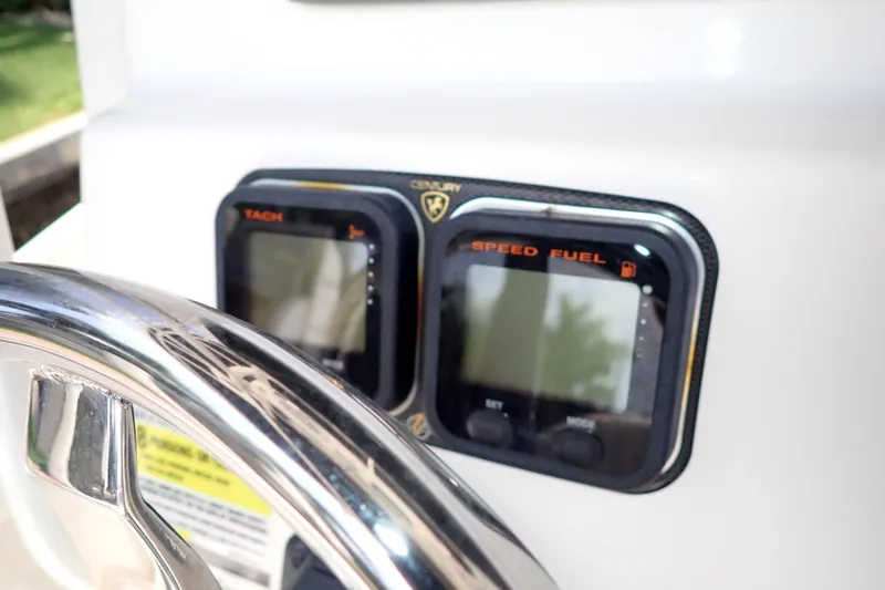 Slide: The Image of Steering wheel and gauges on a 2015 Century 2301 Center Console boat. - 19