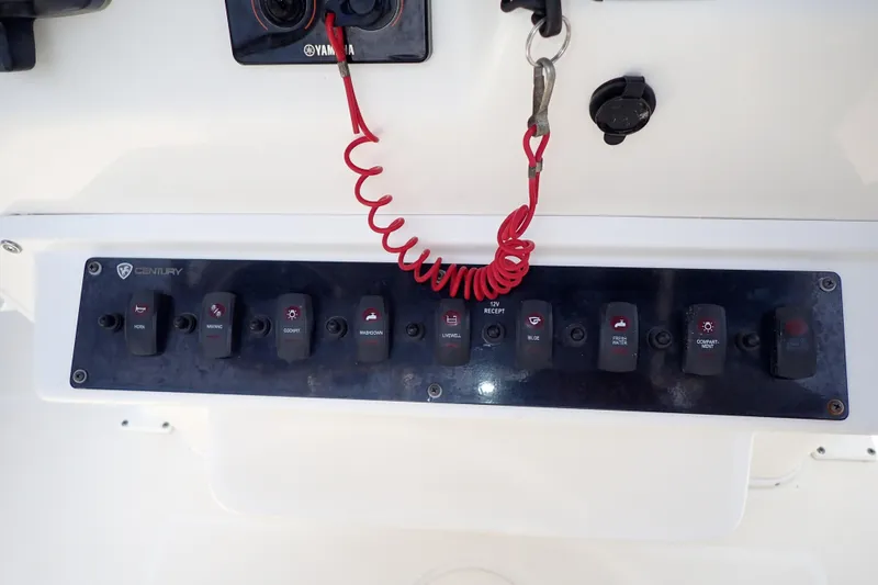Slide: The Image of Control panel of a 2015 Century 2301 Center Console boat with various switches. - 20