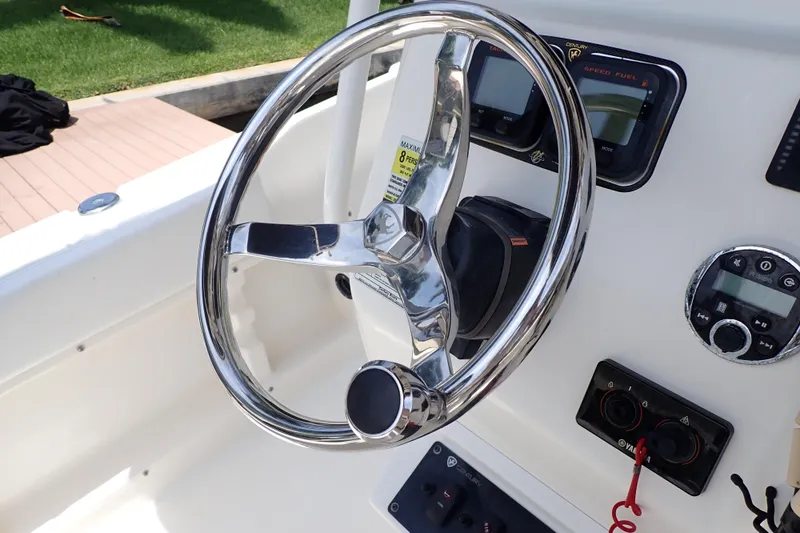 Slide: The Image of Steering wheel and controls of a 2015 Century 2301 Center Console boat. - 21