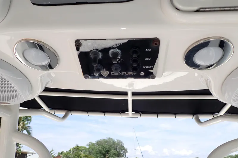 Slide: The Image of 2015 Century 2301 Center Console boat dashboard with control panel and speakers. - 24