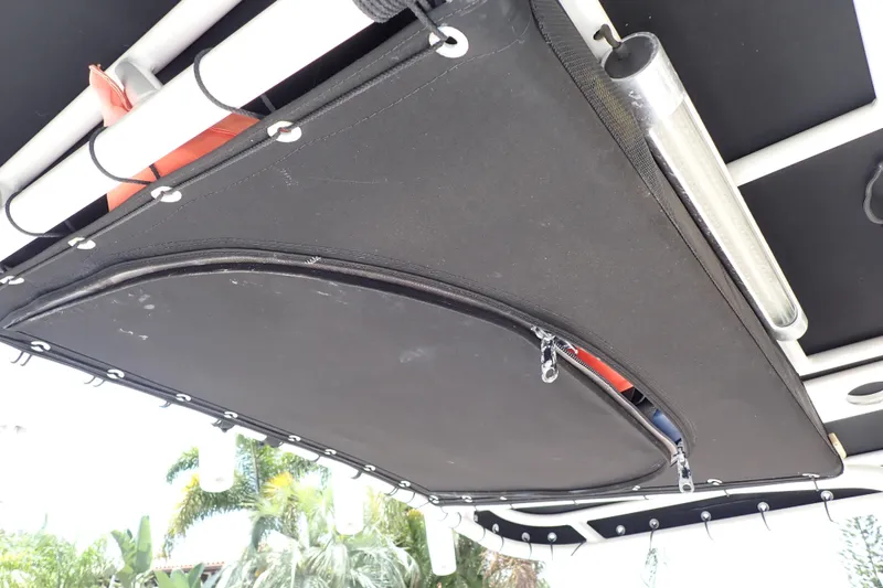 Slide: The Image of 2015 Century 2301 Center Console boat with black T-top storage compartment. - 25