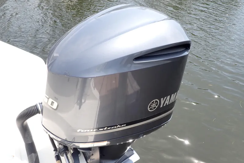 Slide: The Image of Yamaha outboard motor on a 2015 Century 2301 Center Console boat by the water. - 26