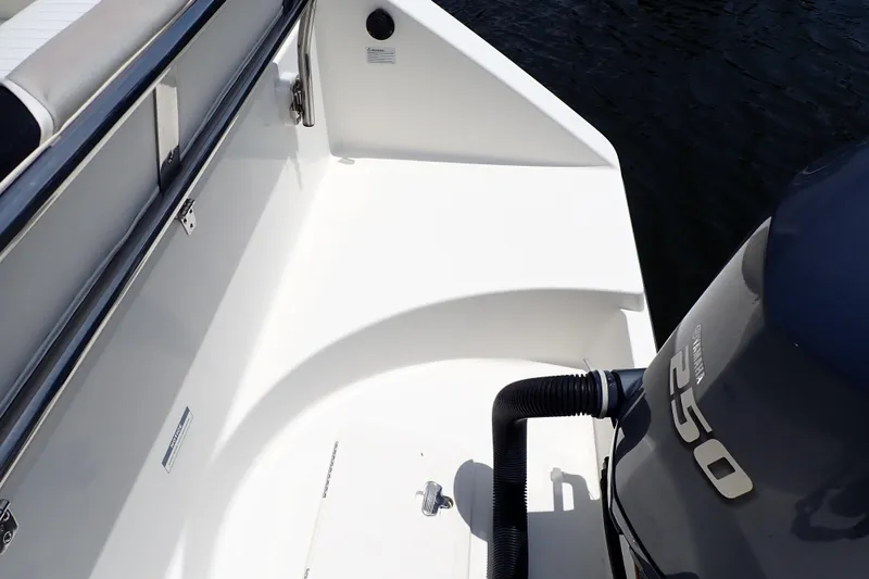 Slide: The Image of 2015 Century 2301 Center Console boat with Yamaha 250 engine, docked by water. - 27