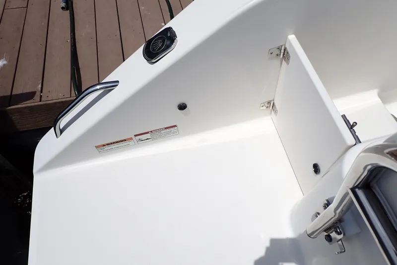 Slide: The Image of 2015 Century 2301 Center Console boat interior with storage compartment and safety warnings. - 28