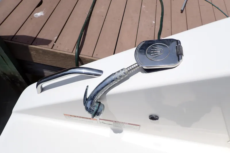 Slide: The Image of 2015 Century 2301 Center Console boat deck with chrome fittings and hose connection. - 29