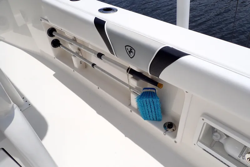 Slide: The Image of Interior view of a 2015 Century 2301 Center Console boat with rod holders and cleaning brush. - 31