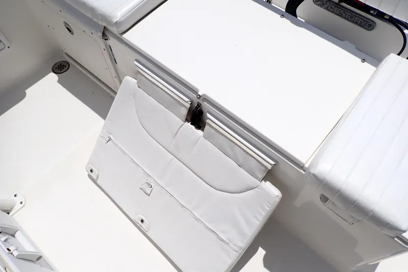 Slide: The Image of 2015 Century 2301 Center Console boat interior with white seating and storage. - 37