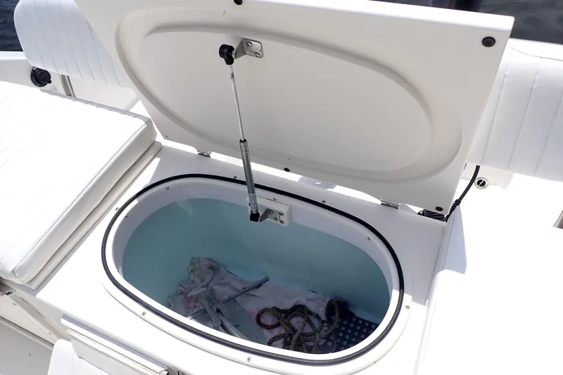 Slide: The Image of Open storage compartment on 2015 Century 2301 Center Console boat. - 38