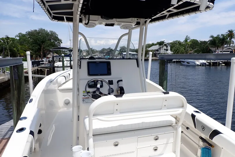 Slide: The Image of 2015 Century 2301 Center Console boat docked by a scenic waterfront. - 4