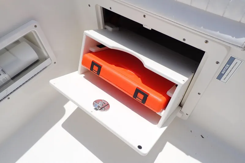 Slide: The Image of Storage compartment on 2015 Century 2301 Center Console boat with orange case inside. - 42