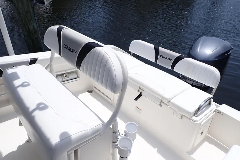 Slide: The Image of 2015 Century 2301 Center Console boat interior with white seating and outboard motor. - 5