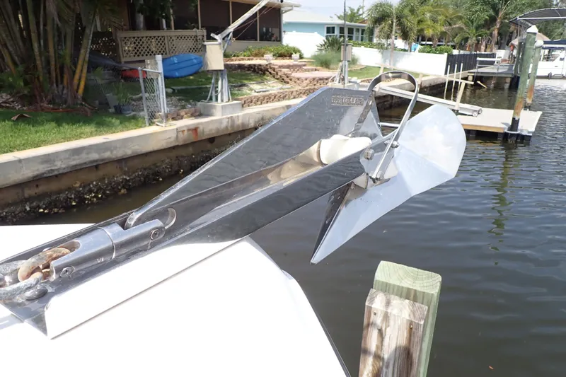 Slide: The Image of Stainless steel anchor on a 2015 Century 2301 Center Console boat docked by a canal. - 51