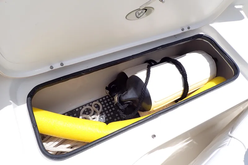 Slide: The Image of Storage compartment of 2015 Century 2301 Center Console boat with fender and rope. - 54