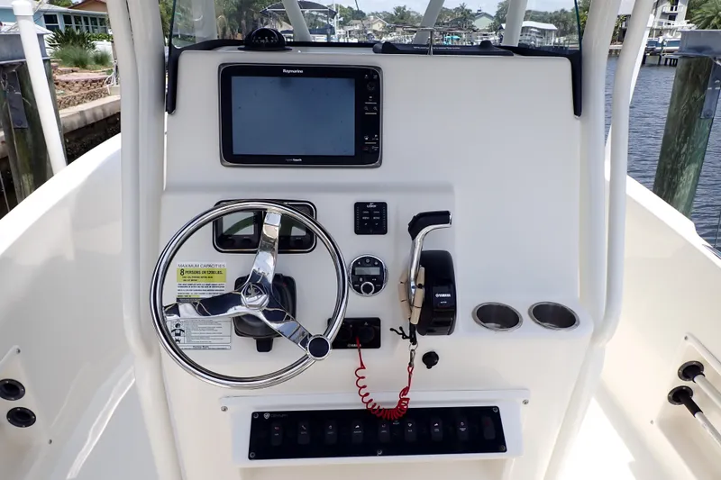 Slide: The Image of Century 2301 Center Console 2015 boat dashboard with steering wheel and navigation system. - 6