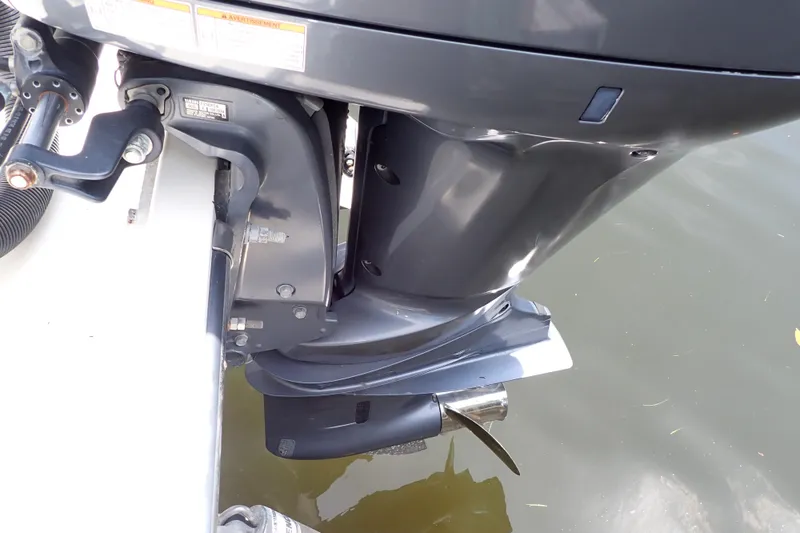 Slide: The Image of Close-up of a 2015 Century 2301 Center Console boat motor in water. - 61