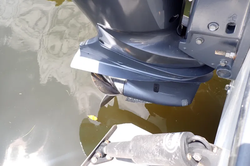 Slide: The Image of Outboard motor of a 2015 Century 2301 Center Console boat in water. - 65