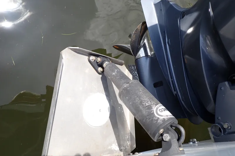 Slide: The Image of Close-up of a 2015 Century 2301 Center Console boat motor and trim tab in water. - 66