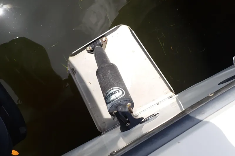 Slide: The Image of Trim tab on a 2015 Century 2301 Center Console boat in water. - 67