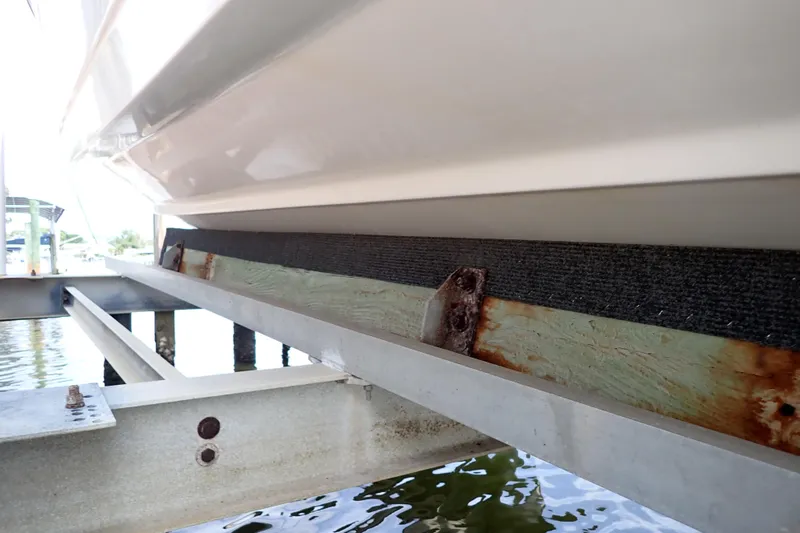 Slide: The Image of 2015 Century 2301 Center Console boat on a dock with visible rust and wear. - 73