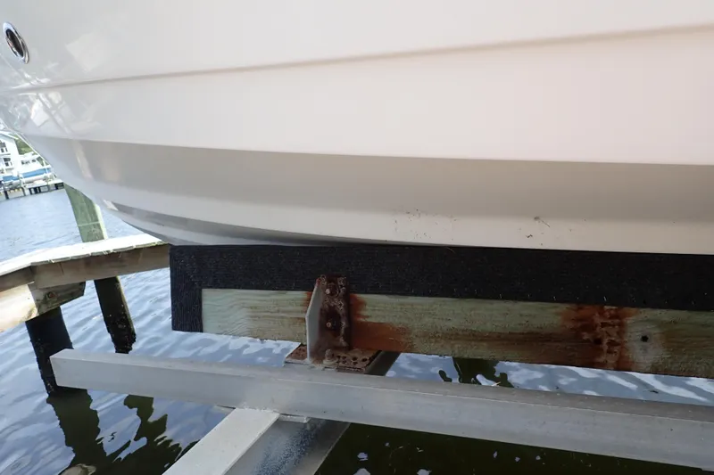 Slide: The Image of 2015 Century 2301 Center Console boat hull on a dock lift, showing rusted support beam. - 74