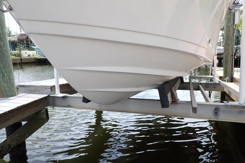 Slide: The Image of 2015 Century 2301 Center Console boat on lift at marina dock. - 75