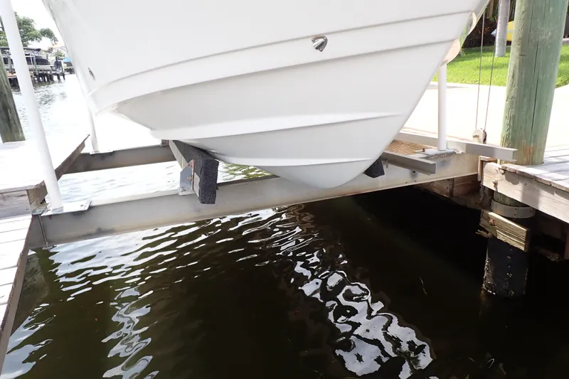 Slide: The Image of 2015 Century 2301 Center Console boat on a lift above water. - 76