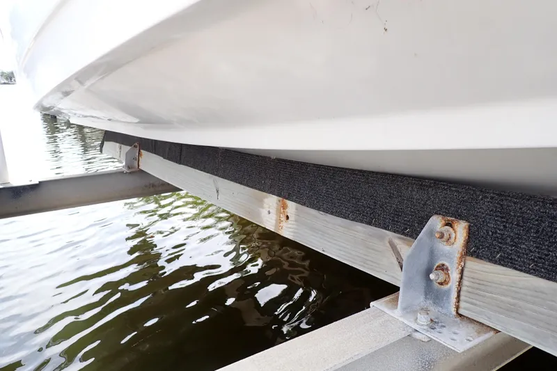 Slide: The Image of 2015 Century 2301 Center Console boat on a dock with visible rusted metal supports. - 77