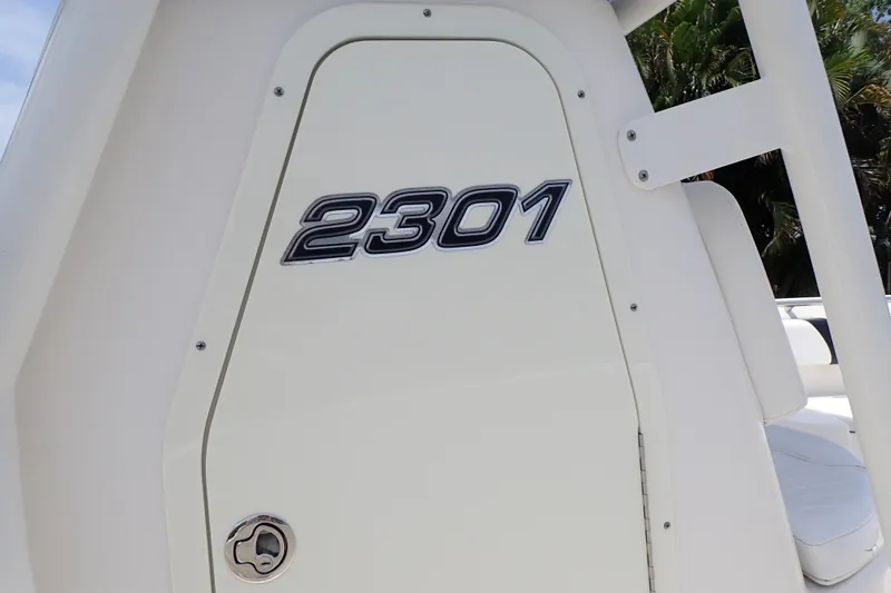 Slide: The Image of Century 2301 Center Console boat, 2015 model, featuring sleek white design and bold "2301" emblem. - 80