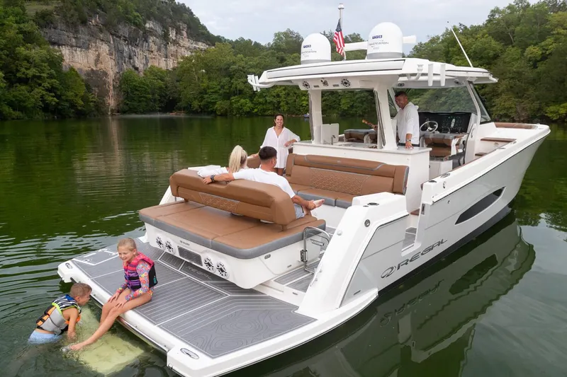 Slide: The Image of Manufacturer Provided Image: 2026 Regal 38 Surf boat on a lake with people enjoying leisure activities. - 4
