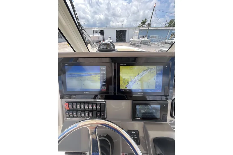 Slide: The Image of 2019 Pursuit S 288 Sport boat dashboard with navigation screens and controls. - 14