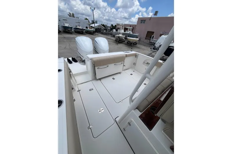 Slide: The Image of 2019 Pursuit S 288 Sport boat interior with dual engines, spacious deck, and seating. - 16