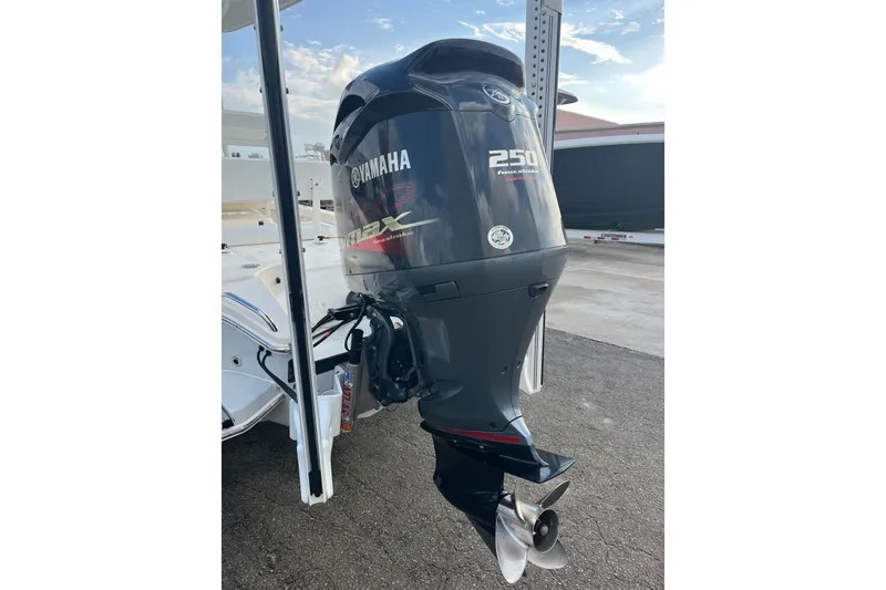 Slide: The Image of 2019 Pursuit S 288 Sport with Yamaha 250 outboard motor, parked outdoors. - 22