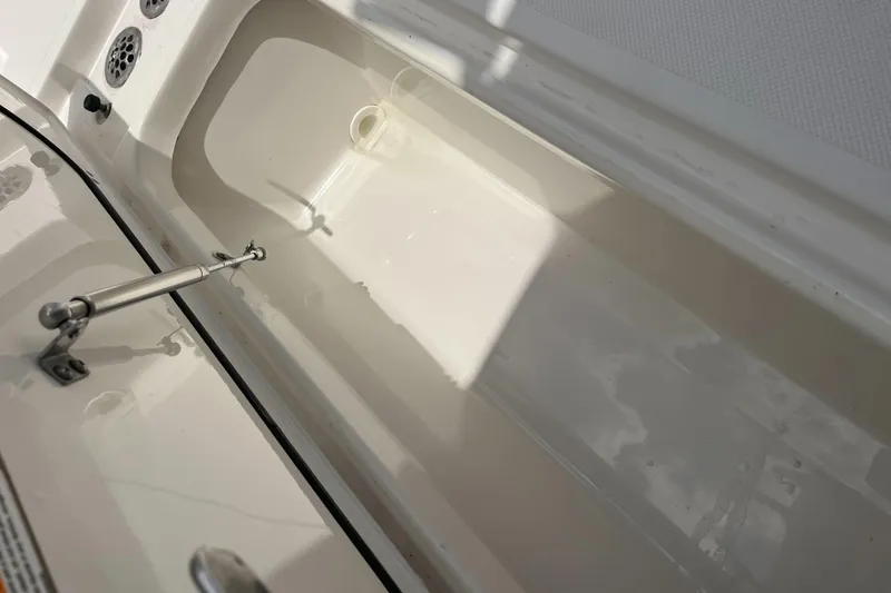 Slide: The Image of Open storage compartment on a 2019 Pursuit S 288 Sport boat. - 23
