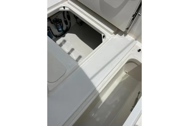 Slide: The Image of Open storage compartments on a 2019 Pursuit S 288 Sport boat. - 24