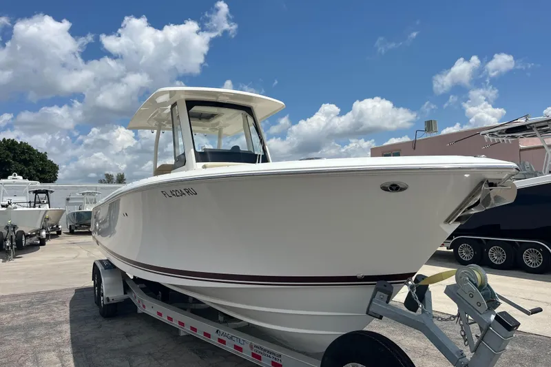 Slide: The Image of 2019 Pursuit S 288 Sport boat on trailer under blue sky. - 3