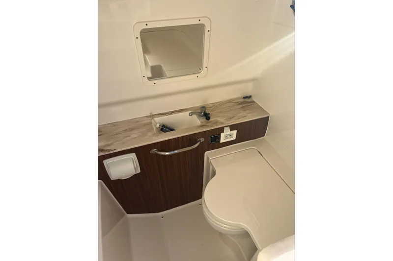 Slide: The Image of 2019 Pursuit S 288 Sport boat interior with sink and mirror. - 30