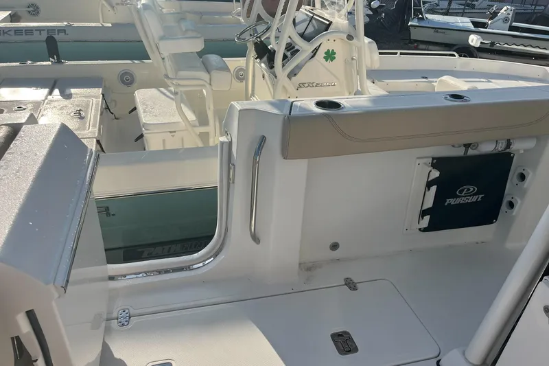 Slide: The Image of 2019 Pursuit S 288 Sport boat interior with seating and steering console. - 31